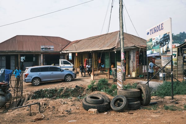 Stack of tires in front of store fronts, Uganda