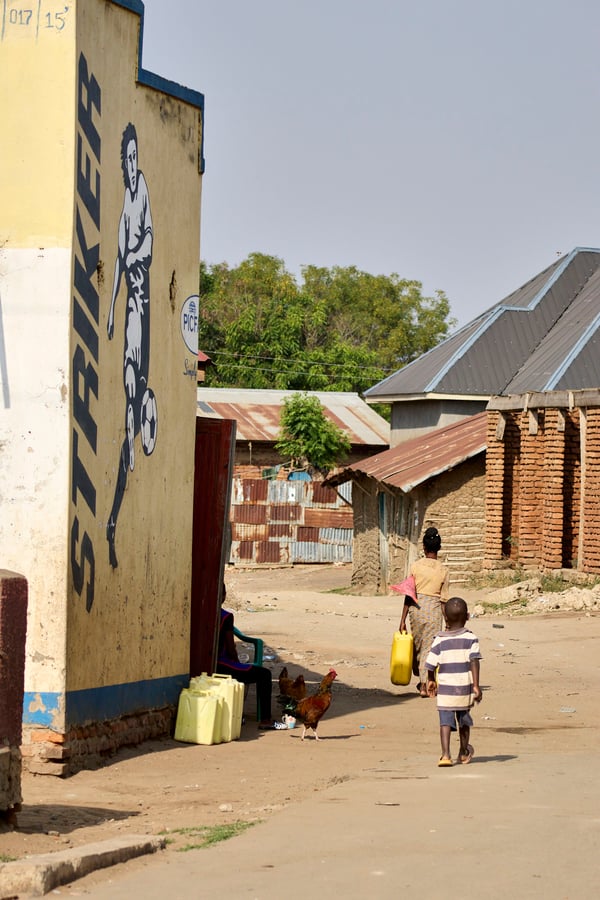 Mother and child walking home, Uganda