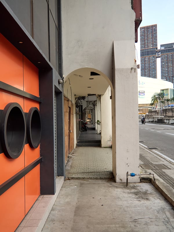 Orange wall covered sidewalk look through, Kuala Lumpur, Malaysia