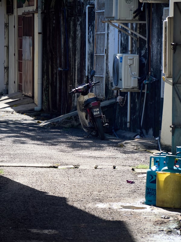Look through alleyway and motorcycle, strong light, Penang, Malaysia