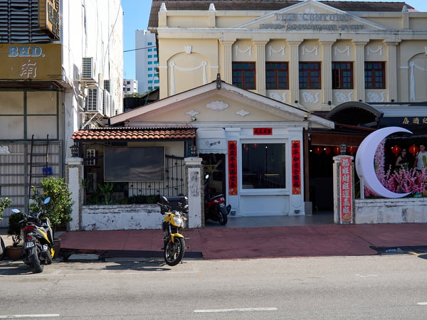 Business front with parked motorcycles, strong light, Penang, Malaysia