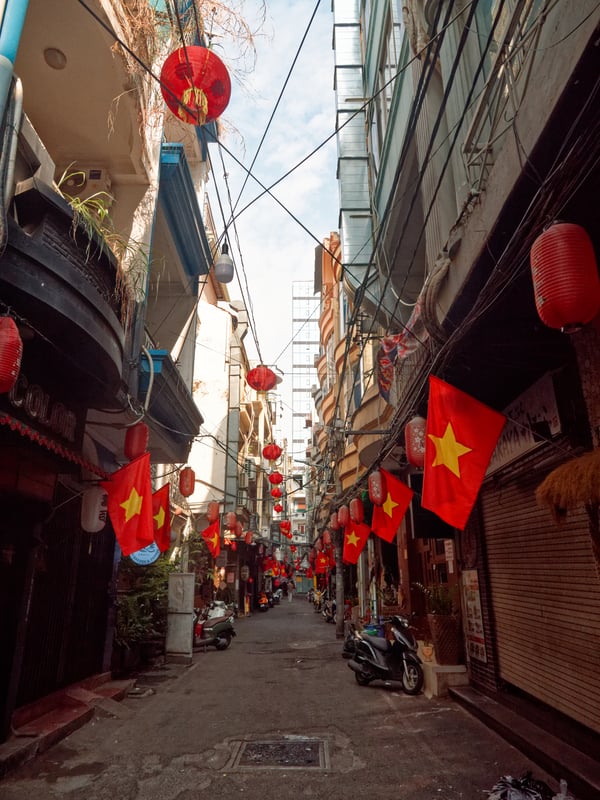 Decorated alley way with Vietnam flags, Ho Chi Min City, Vietnam
