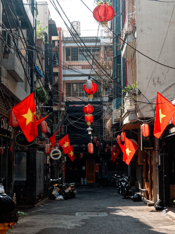 Decorated alley way with Vietnam flags, Ho Chi Min City, Vietnam